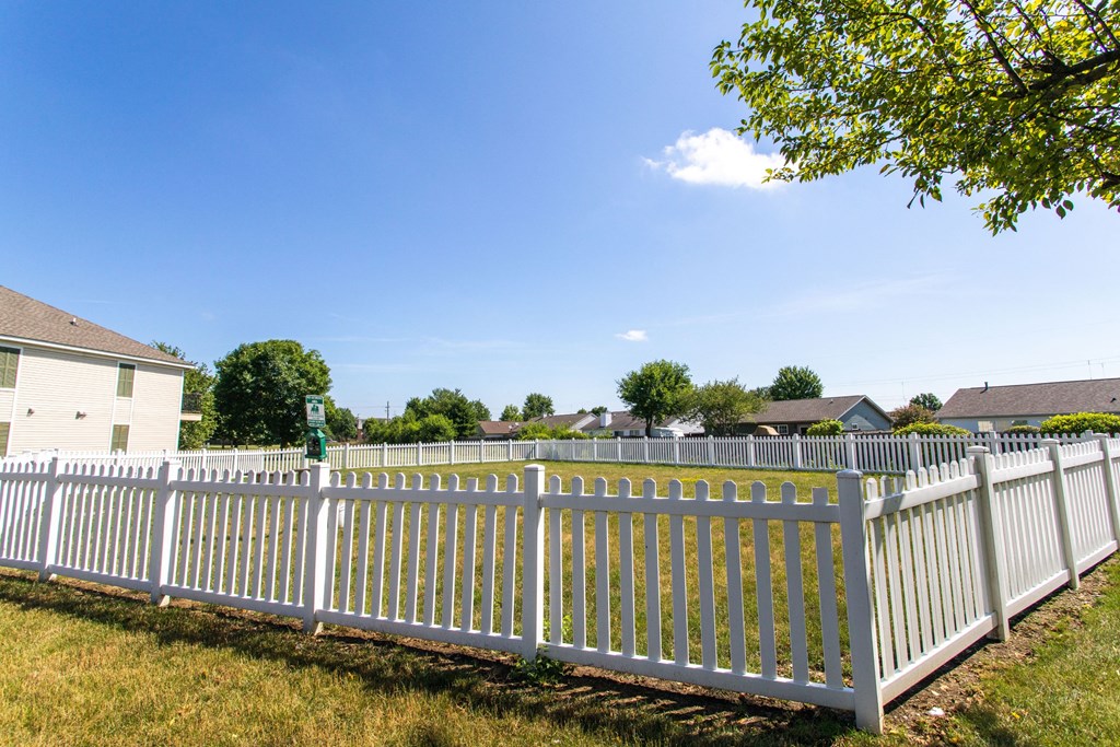 a white picket fence in front of a house