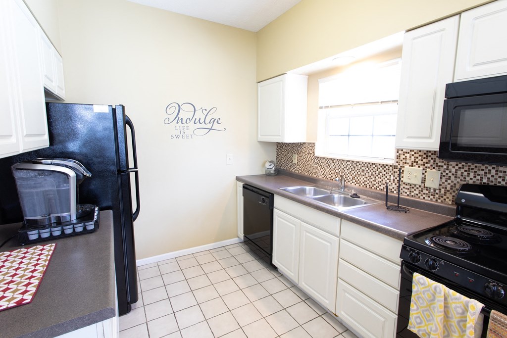 a kitchen with a sink and a refrigerator