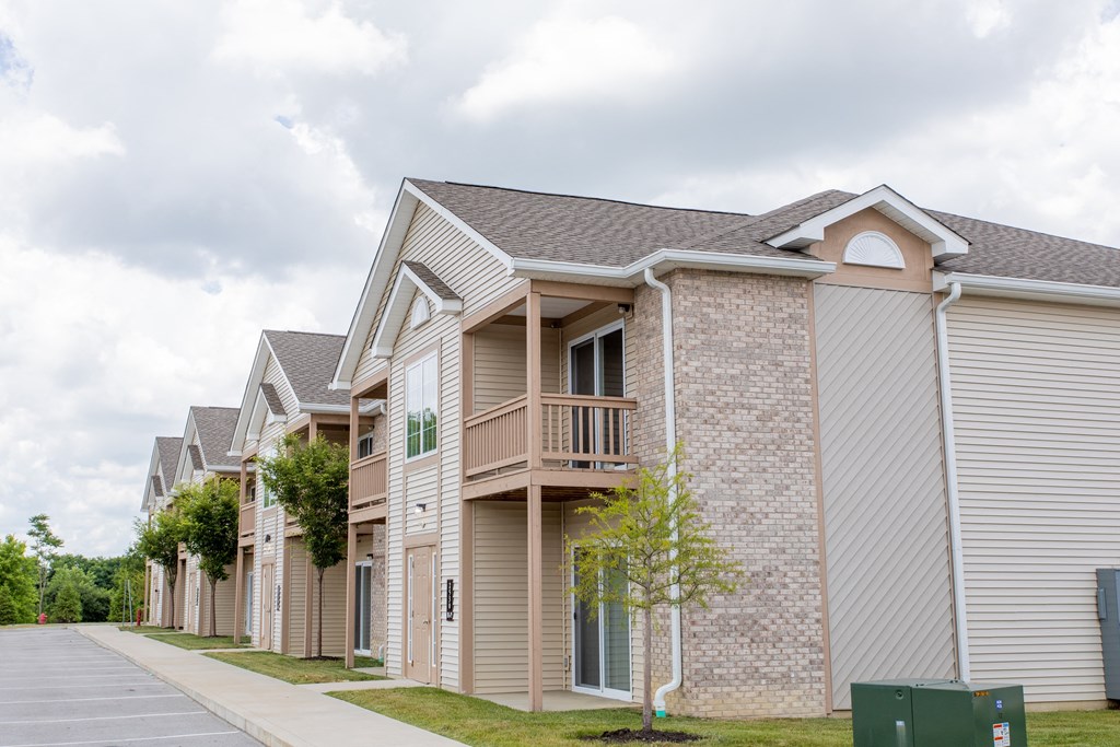 a row of houses with a sidewalk in front of them