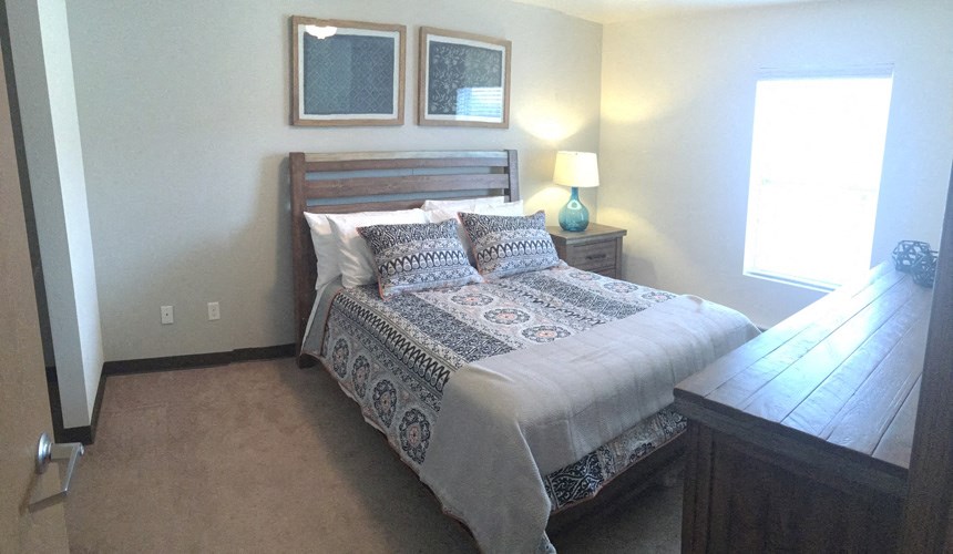 a bedroom with a bed and a dresser
