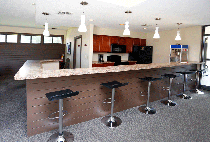 a kitchen with a counter top and stools