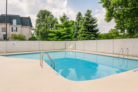 A small pool with a metal fence around it.