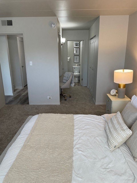 a bedroom with a bed and a lamp