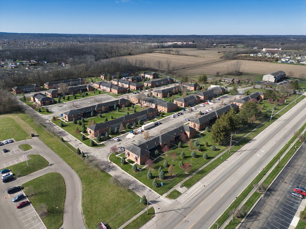 an aerial view of a neighborhood with houses and a highway