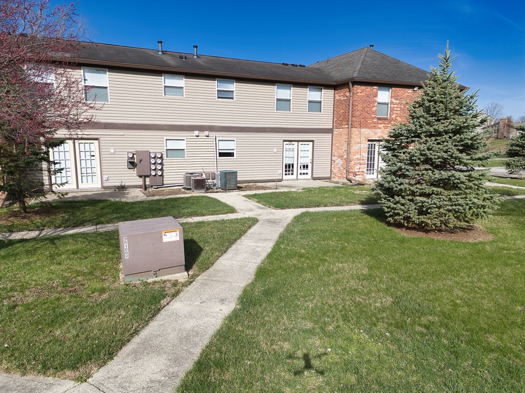 the front of a house with a yard and a mailbox