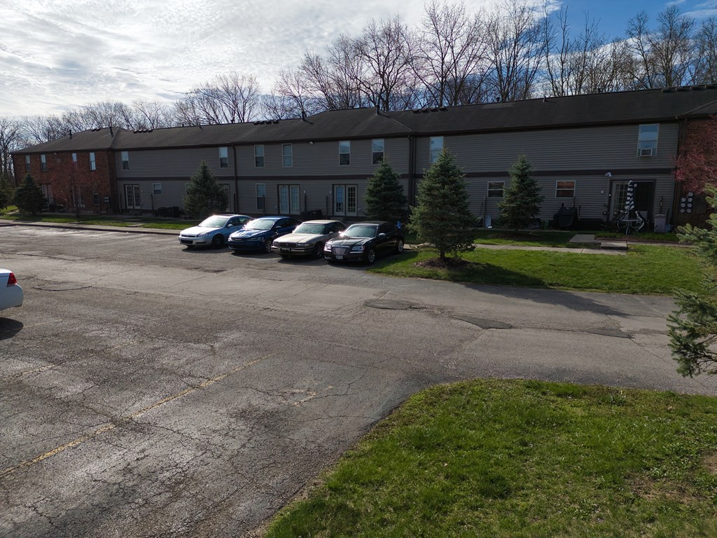 a parking lot with cars in front of a building