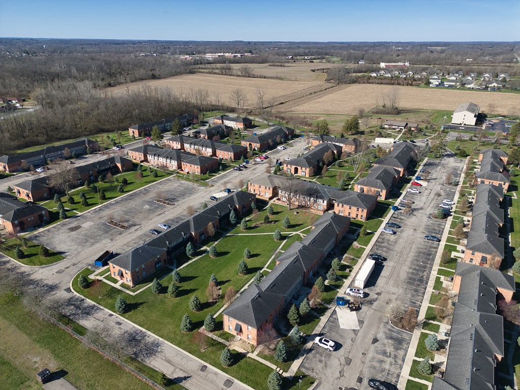 an aerial view of a neighborhood of houses and cars