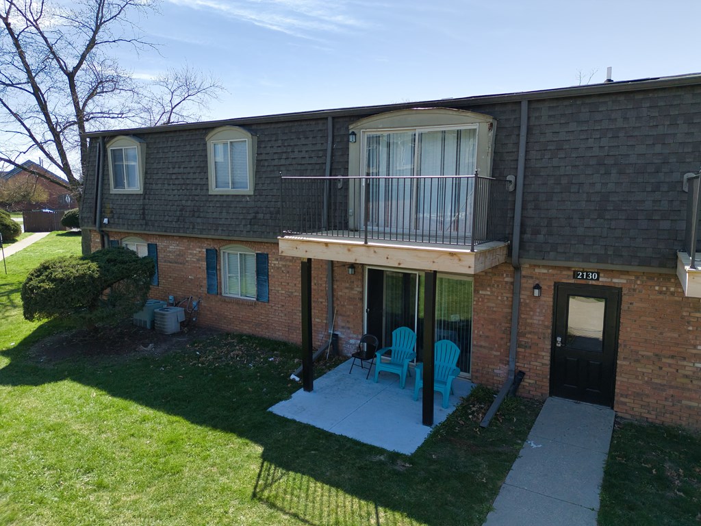 an aerial view of a brick house with a balcony