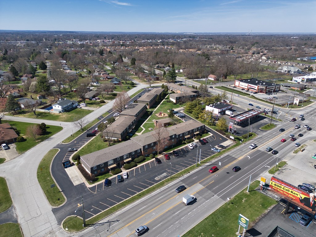 an aerial view of a city street with cars and buildings