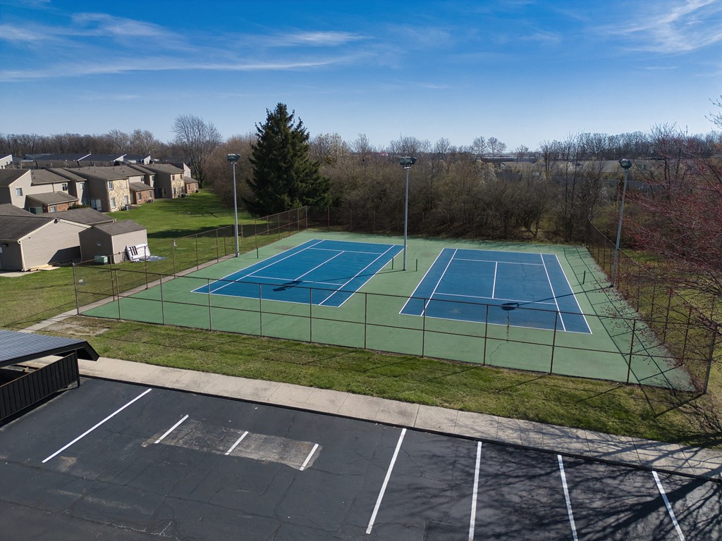 an aerial view of a tennis court with two tennis courts on a green tennis court