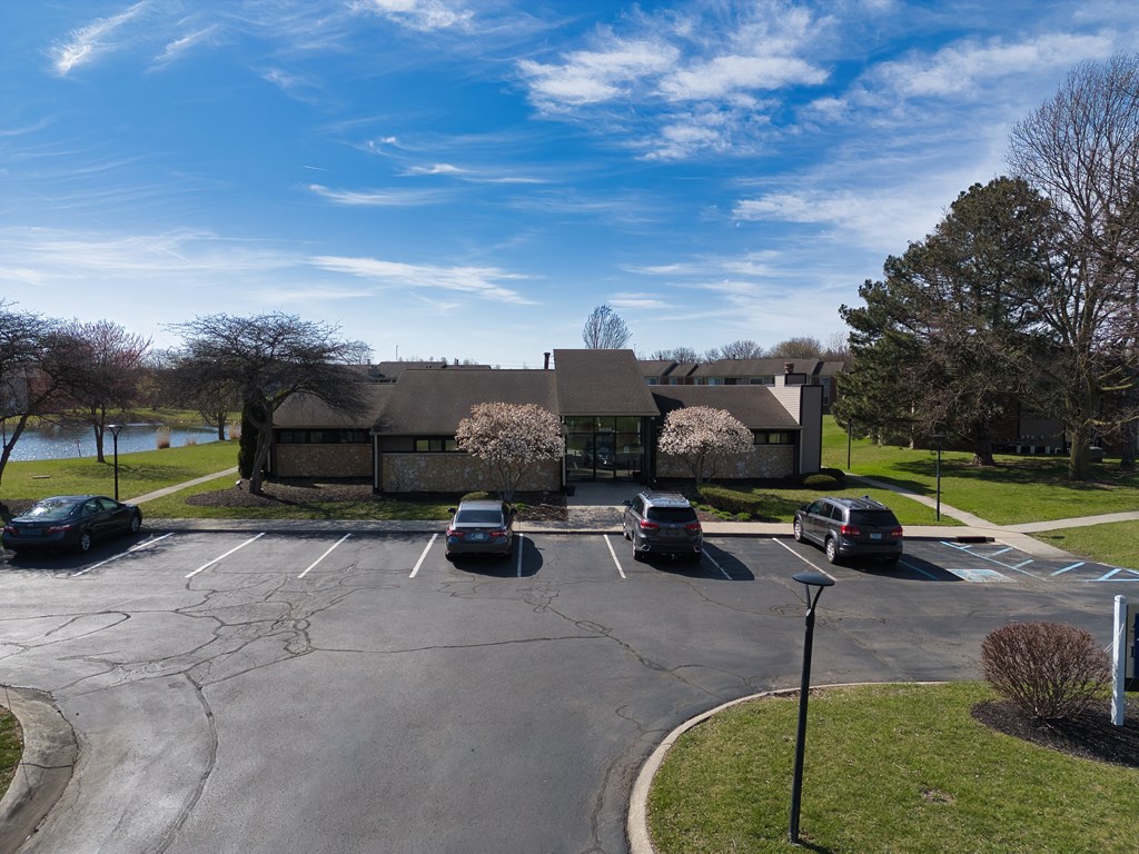 a parking lot with cars in front of a house