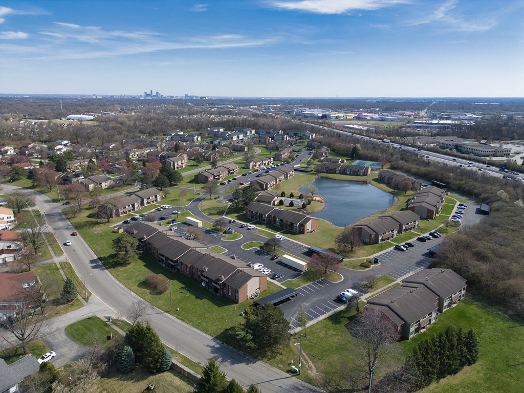 an aerial view of a neighborhood with houses and a lake