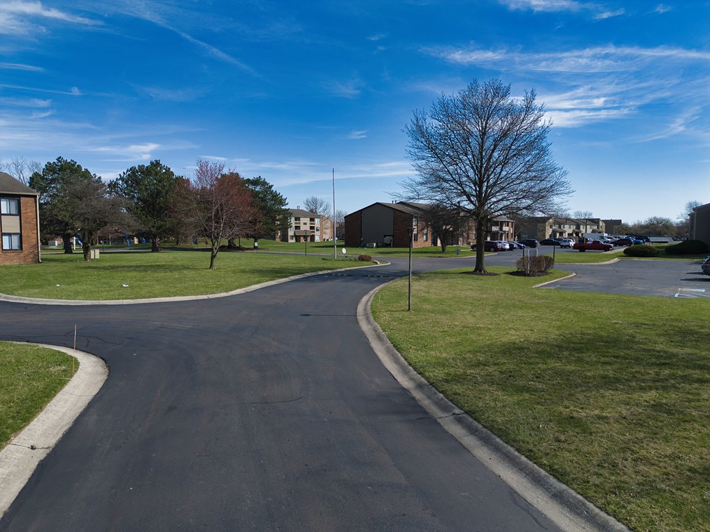 a roundabout in the middle of a neighborhood with houses and trees