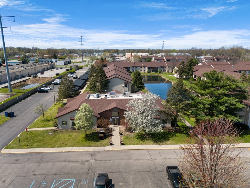 an aerial view of a neighborhood with a pond and houses at The Element @ St Andrews, Indiana, 46545