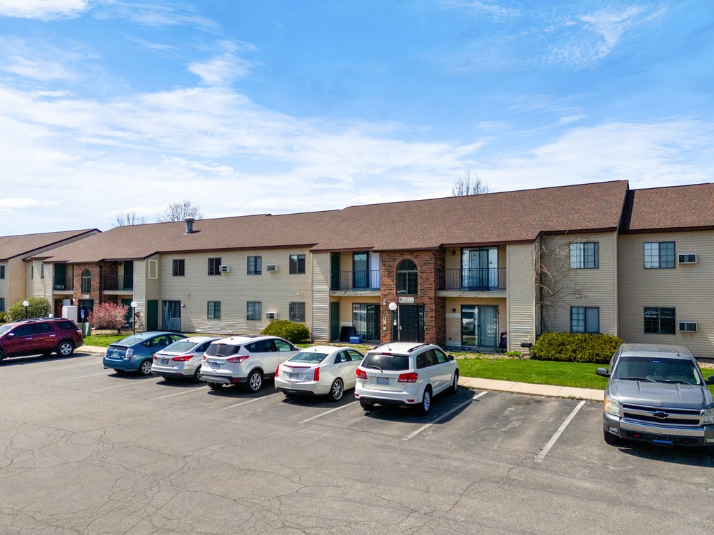 a large building with cars parked in a parking lot at The Element @ St Andrews, Mishawaka, IN, 46545