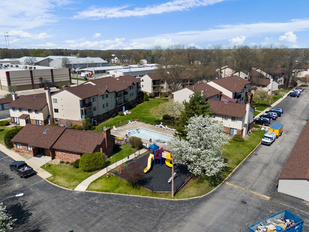 an aerial view of a neighborhood of houses with a playground and a pool at The Element @ St Andrews, Mishawaka, Indiana