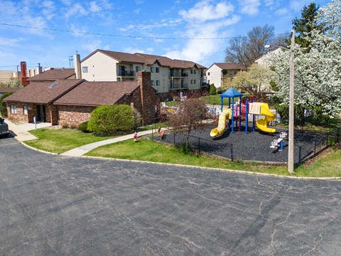 a playground in front of a house with a childs