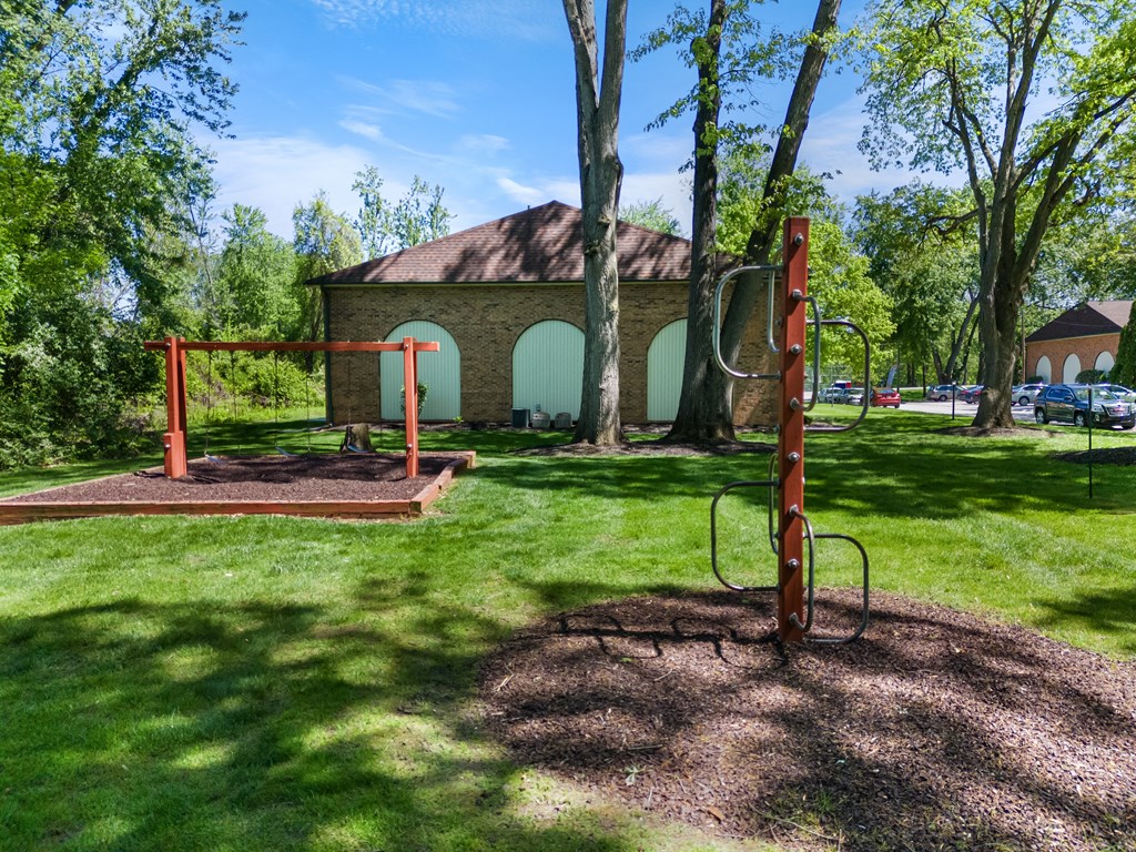 a playground in a park with a church in the background
