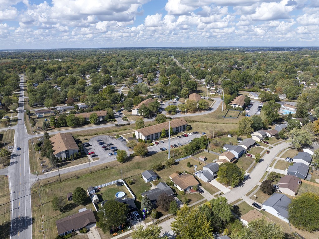 A suburban neighborhood with houses and a parking lot.