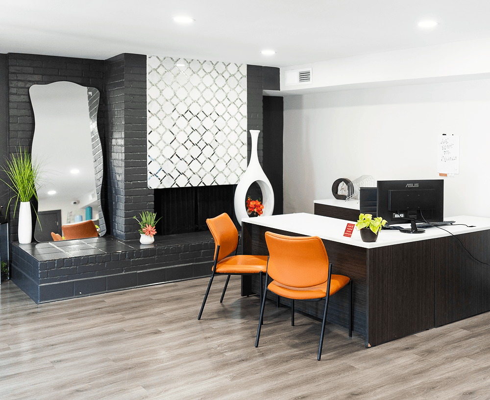 an office space with a desk and orange chairs at La Bella Apartments, Fort Worth, TX, 76116