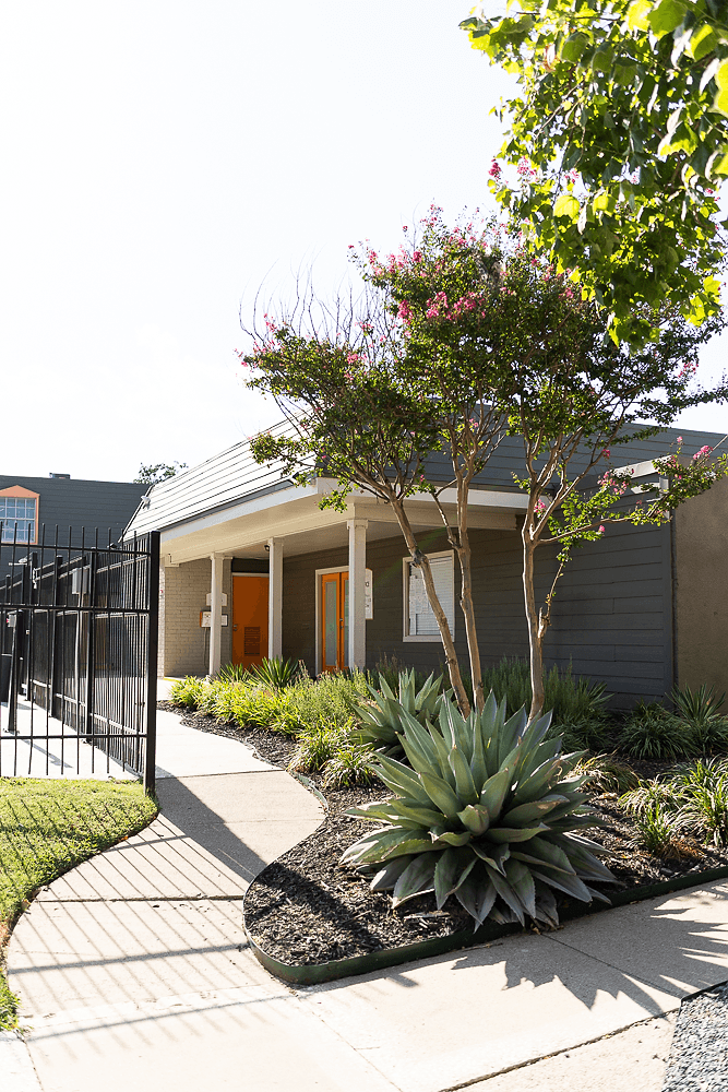 a house with a sidewalk and plants in front of it at La Bella Apartments, Fort Worth, 76116