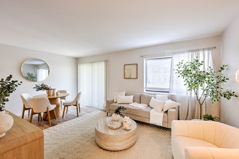 A living room with a couch, chairs, and a coffee table.