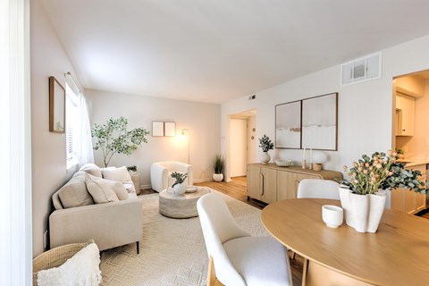 A well-lit, modern living room with a neutral color scheme and contemporary furniture.