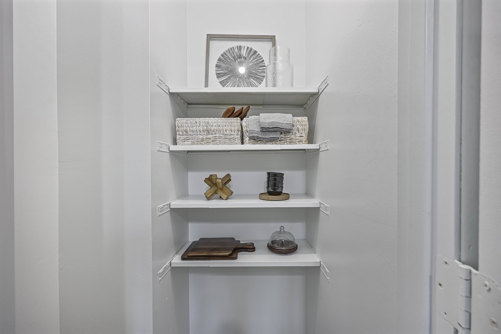A white shelf with various objects on it.