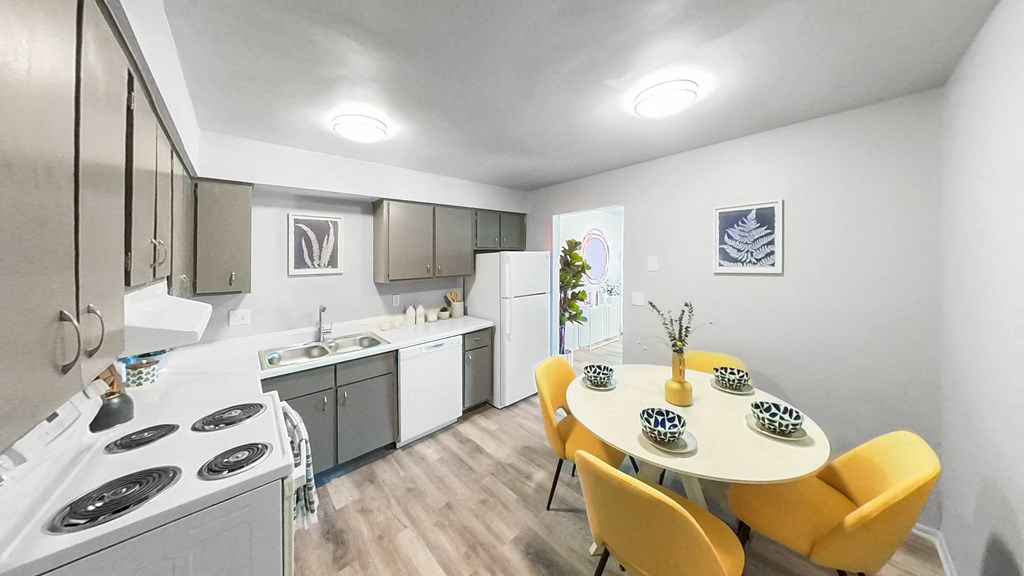 a kitchen and dining room with a table and chairs