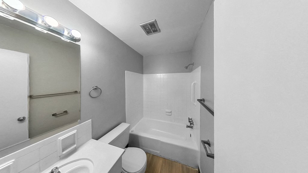 a bathroom with a sink toilet and a bath tub
