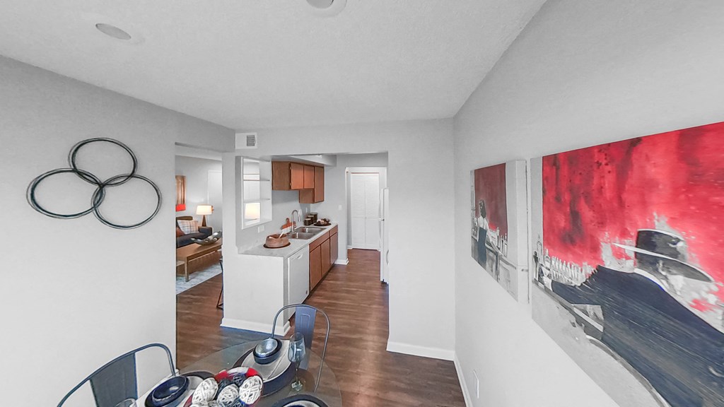 a living room with a dining room table and a kitchen