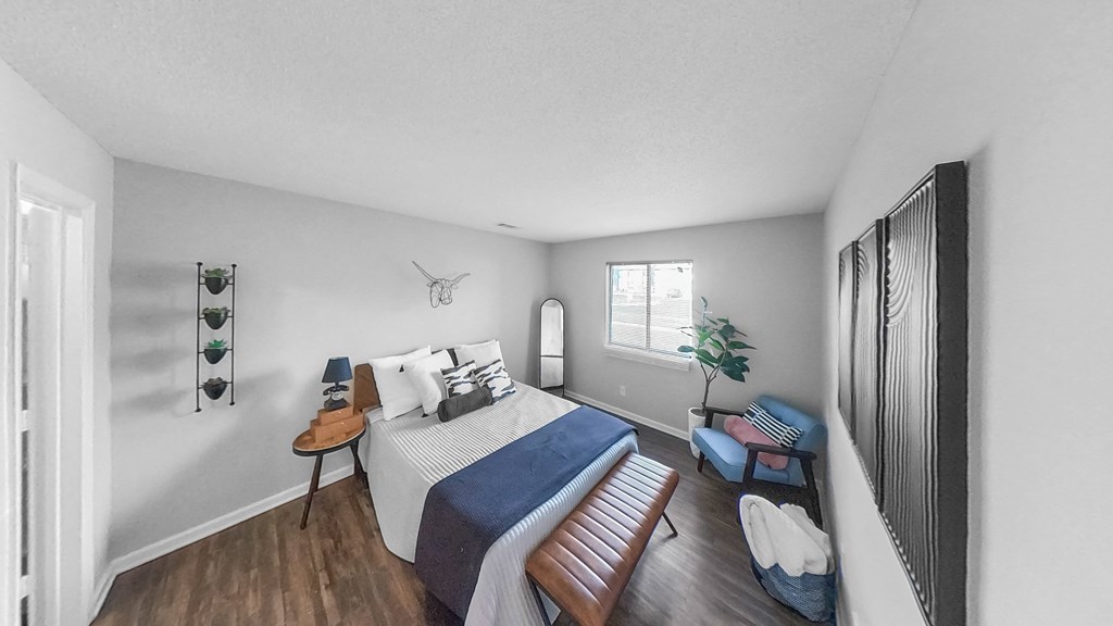 a bedroom with a large bed and a window