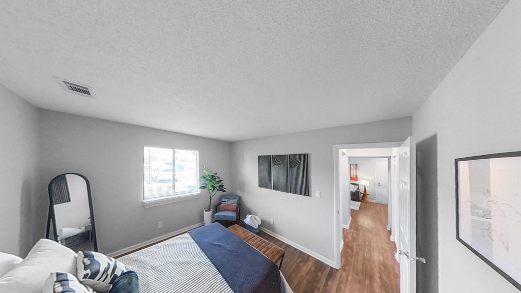 a bedroom with a bed and a mirror on the wall