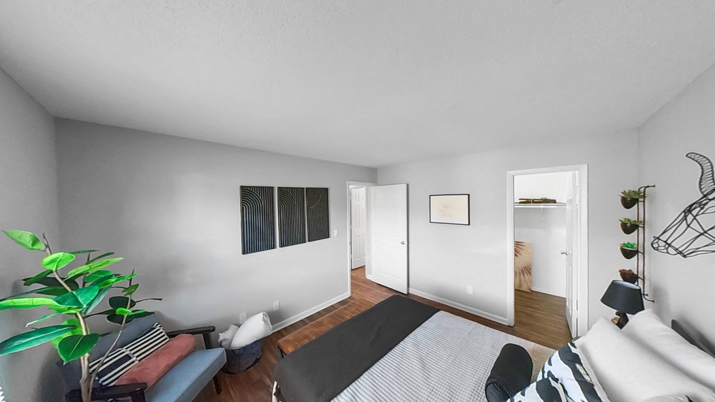 a bedroom with a bed and a door to a bathroom