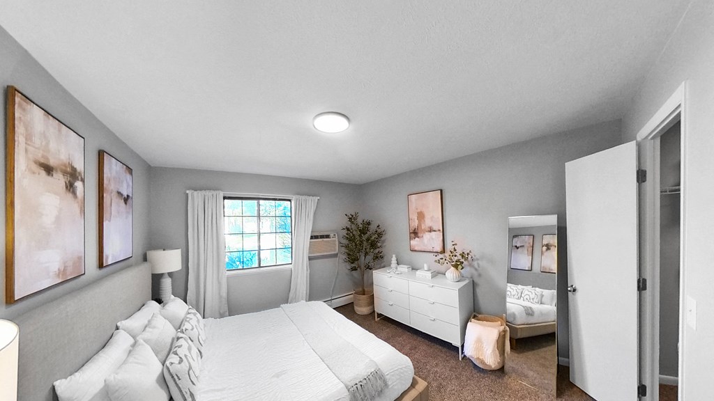 a bedroom with a bed and a dresser and a window at The Element @ St Andrews, Mishawaka, Indiana