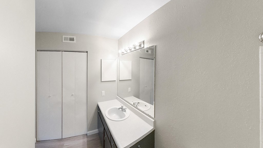 an empty bathroom with a sink and a mirror