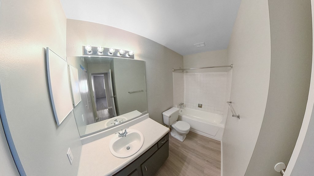 a bathroom with a sink and a toilet and a shower