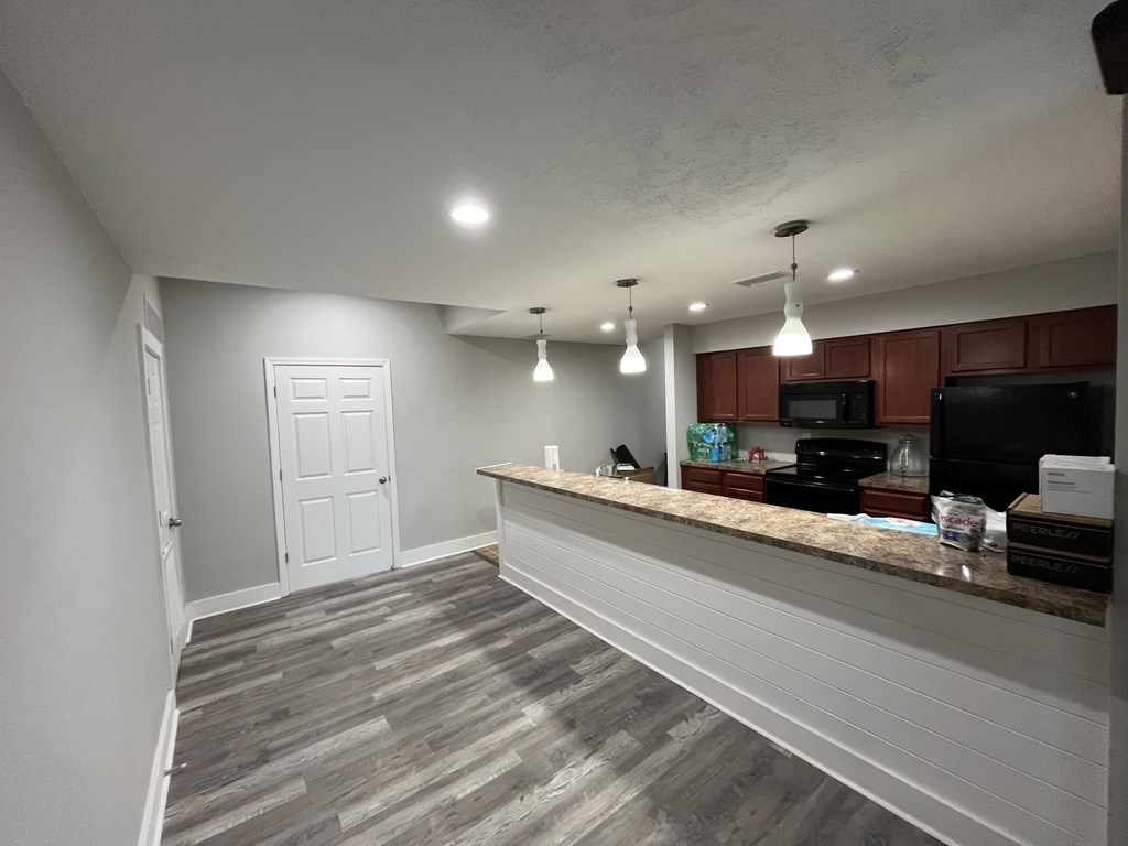 A white door is in a room with a counter.