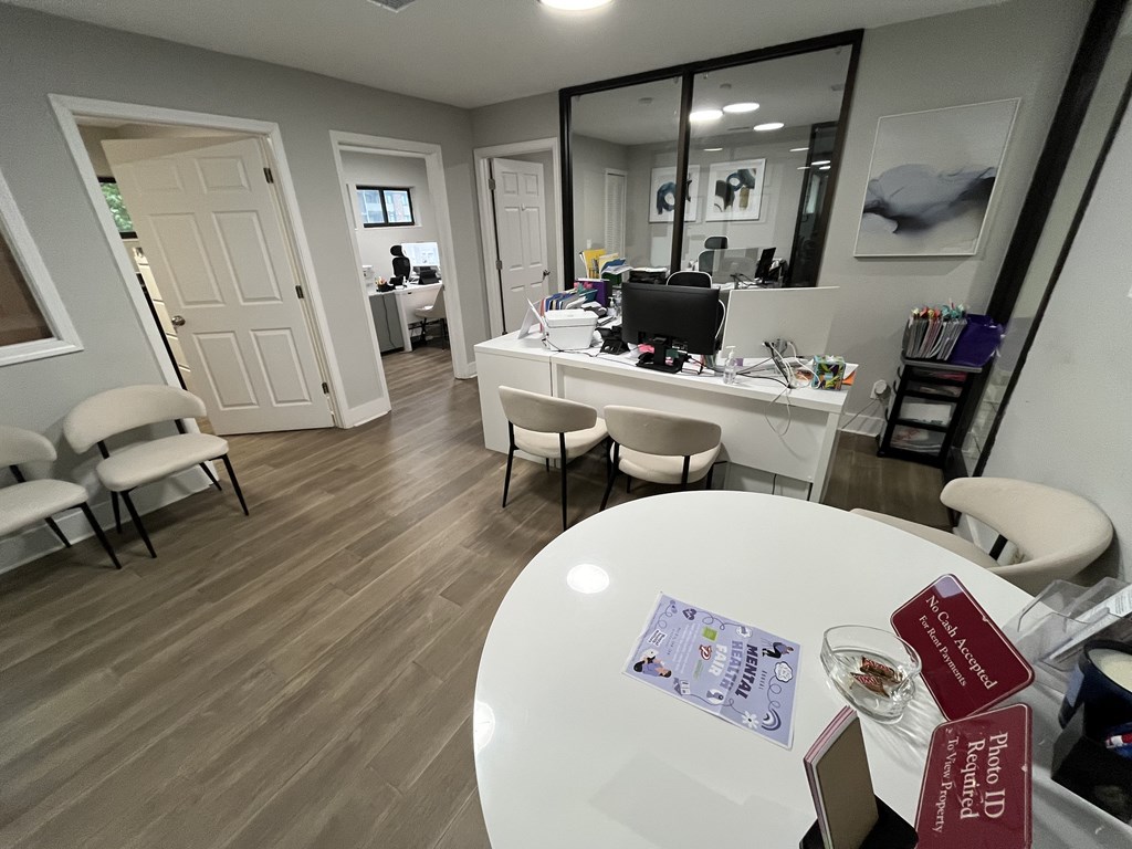 A conference room with a white table and chairs.