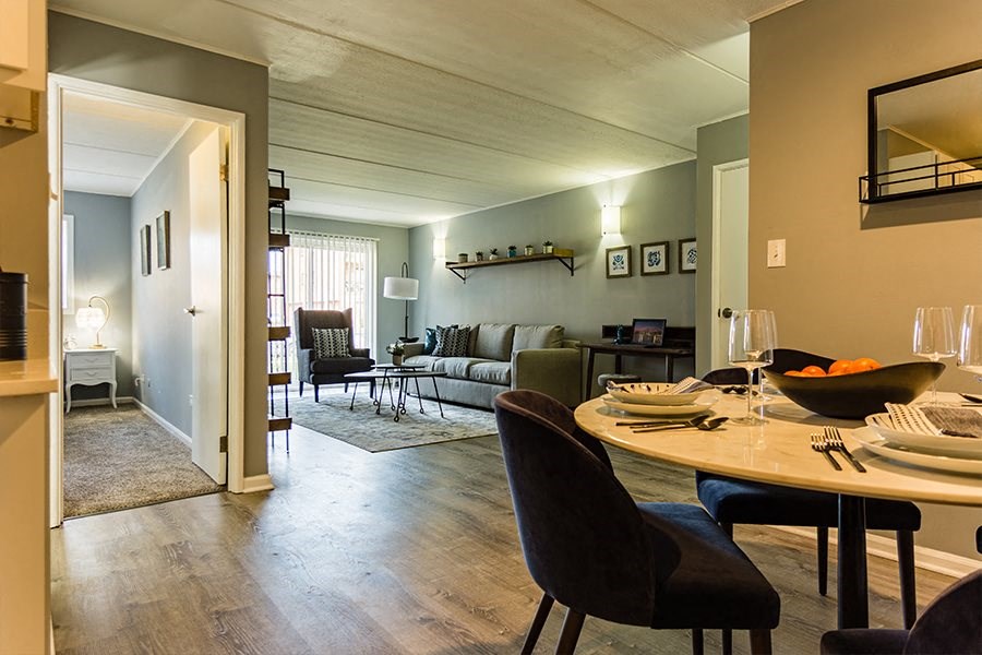 a living room and dining room with a table and chairs