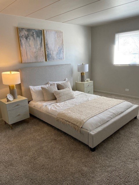 a bedroom with a bed and two lamps