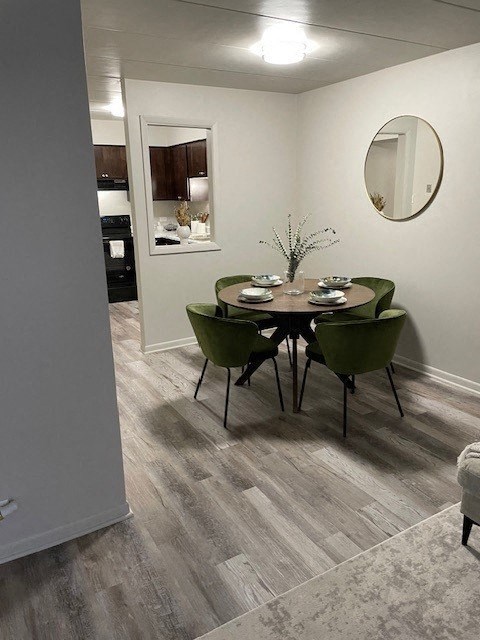 a dining room with a table and green chairs