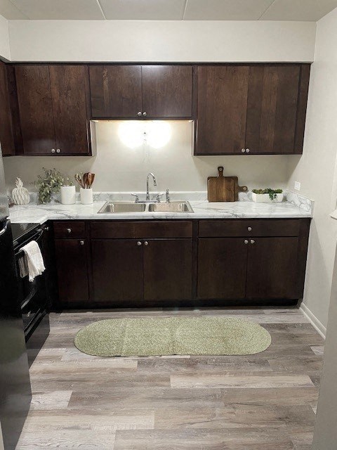 a kitchen with wooden cabinets and a sink and a rug