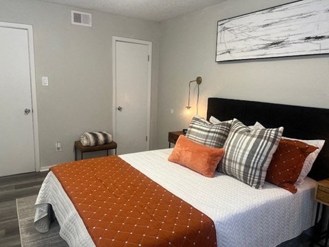 a bedroom with a bed with pillows on it