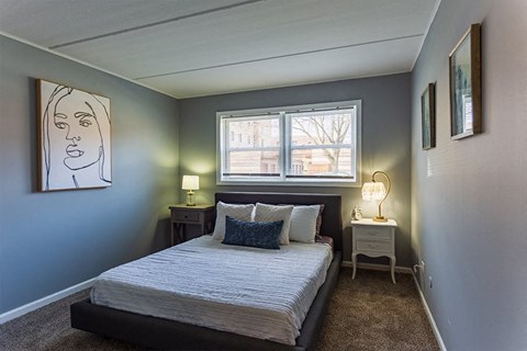 a small bedroom with a bed and a window
