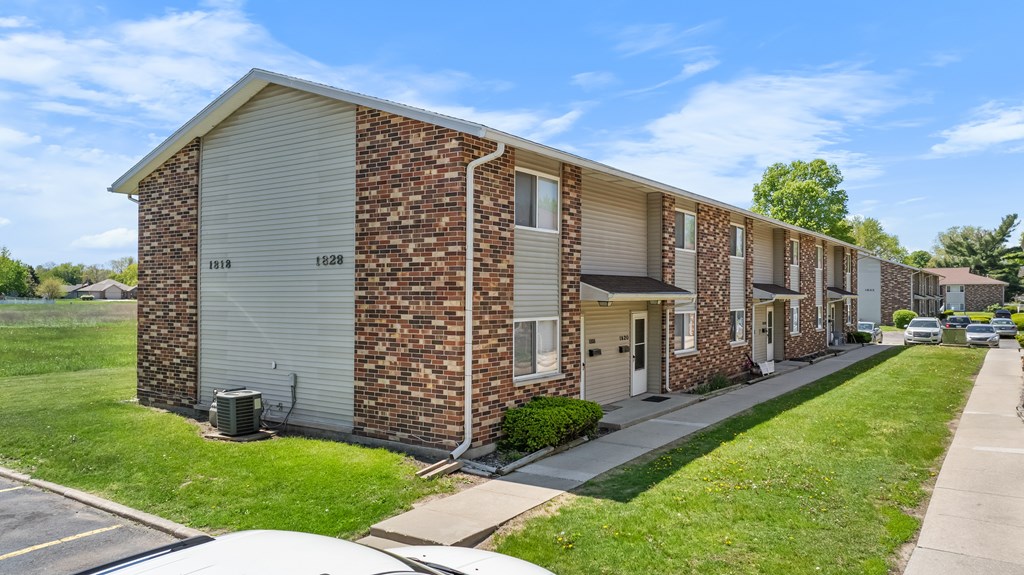 A row of brick apartment buildings with garage doors.