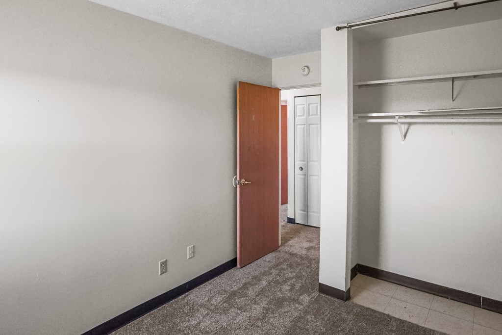 A room with a brown door and a white door.