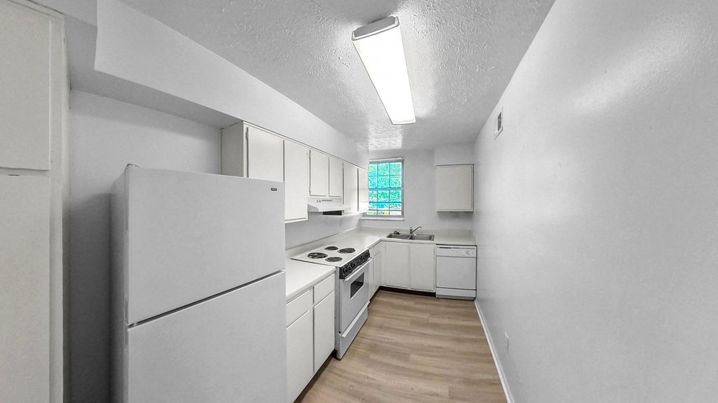 a white kitchen with white appliances and white cabinetsat Wood Creek Apartments, Fort Wayne, 46835