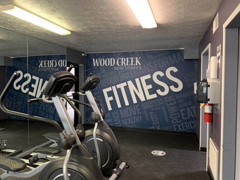 a spin bike in a gym with a wall that says fitness