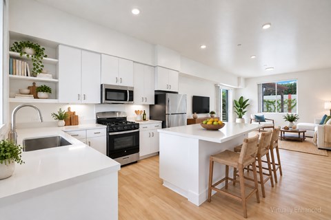 A modern kitchen with white cabinets and a large island.